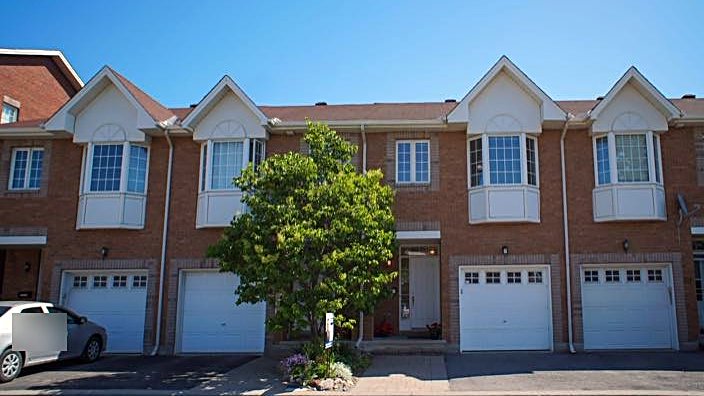Front exterior of a sold townhome in a sunny row